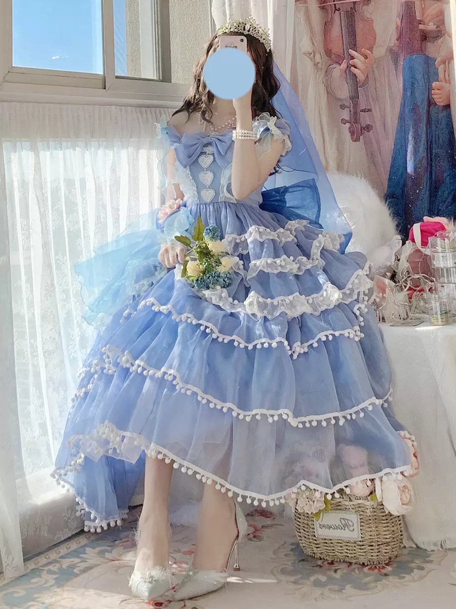Blue sweet lolita bridal dress with ruffled tiered skirt, white lace details, and bridal bouquet - studio indoor setting