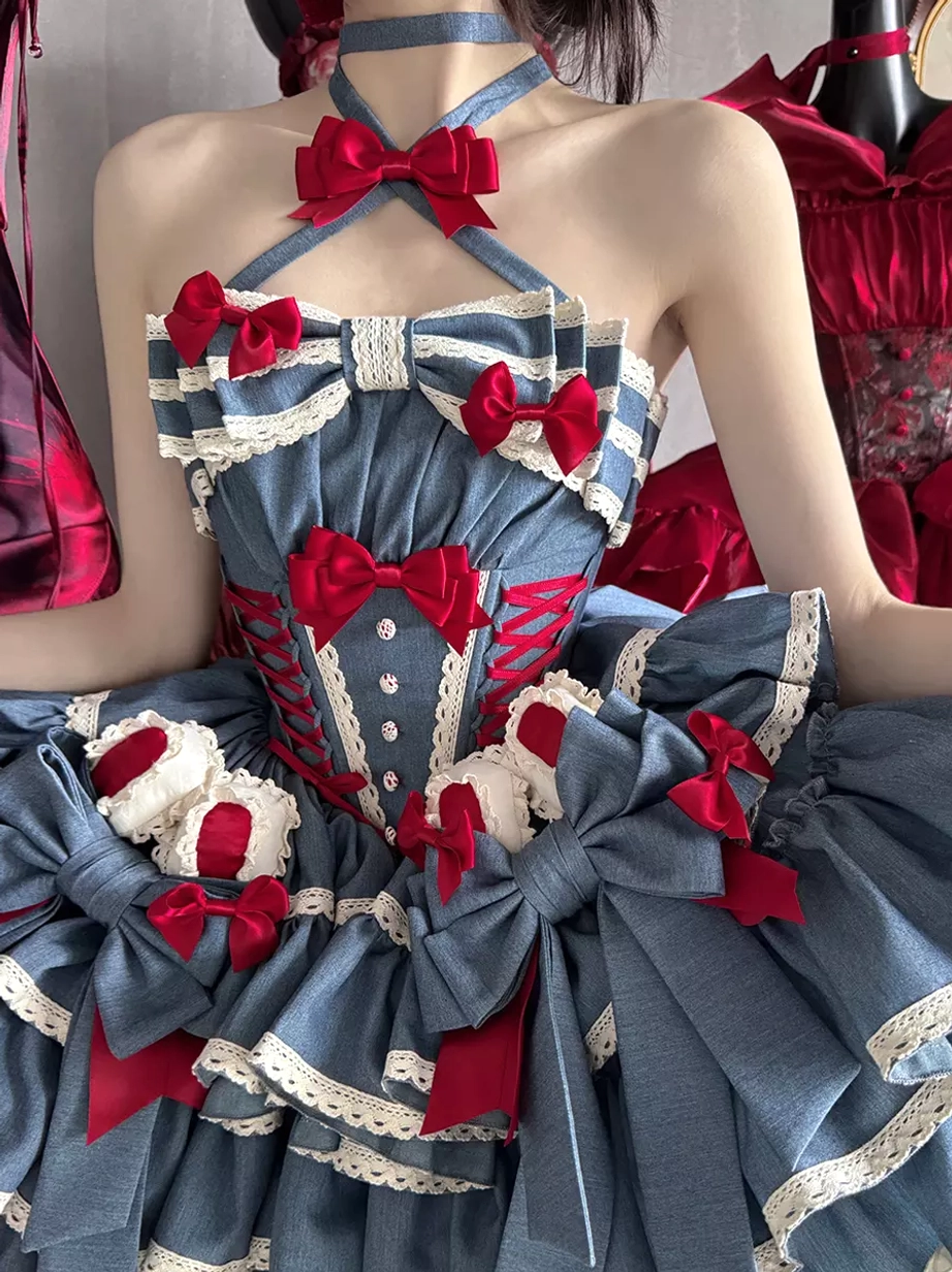 Close-up front bodice of blue sweet lolita dress showing corset-style construction red ribbon bows and white lace edging