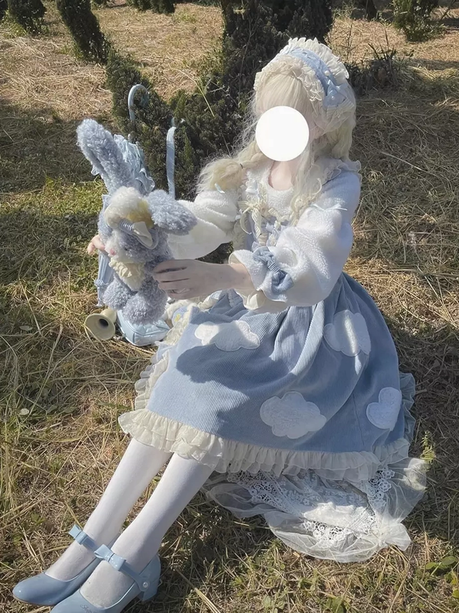 Blue long sleeve lolita dress side shot model grassland scene cloud patches plush sleeves rabbit plush toy