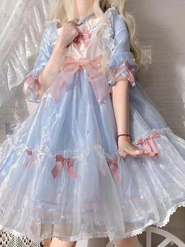 Blue sweet lolita fairy dress close-up front showing big pink bow ruffled cuffs lace hem and sheer tulle fabric