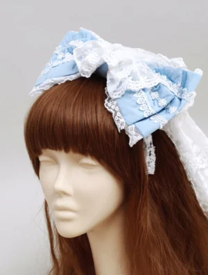 Blue and white lolita headdress front view on mannequin with brown bangs wig, showing complete multi-layered bow structure and romantic Sweet Lolita aesthetic