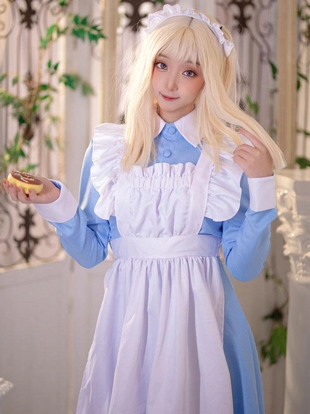 Blue and white maid lolita dress with long cuffs ruffled apron and holding cookie prop vintage gate