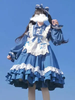 Blue and white sweet lolita dress three-quarter side view showing full ruffled skirt volume, white frilled apron, puffed cuffs, and large coordinating hair bow