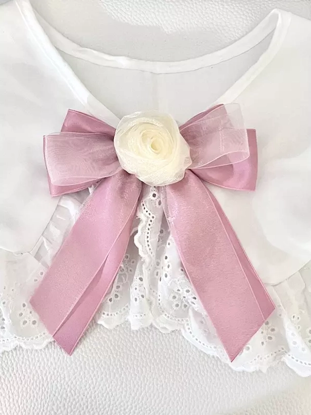 Blush pink sheer organza bow hair clip with cream rose decoration paired with white lace collar, front overhead view of sweet lolita floral accessory