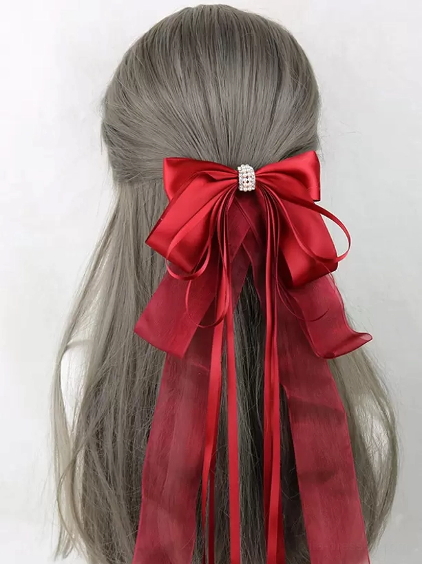 Bright red satin bow hair accessory with rhinestone center decoration and thick long ribbon streamers, sweet lolita headdress back view