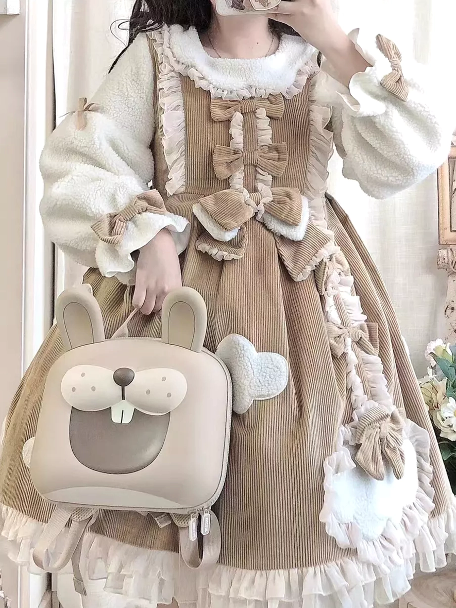 Brown corduroy lolita dress with contrast plush sleeves bow decorations cloud patches model holding handbag