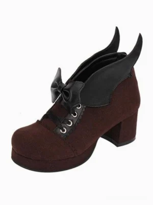Brown Gothic Lolita chunky heel pumps with bat wing bow and lace-up metal eyelets, single shoe front view demonstrating round toe construction