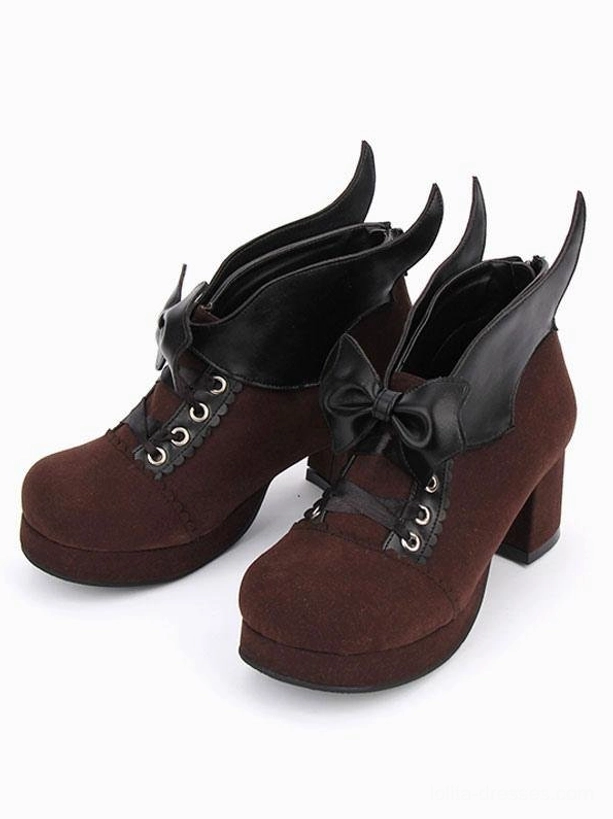 Pair of brown Gothic Lolita chunky heel pumps with bat wing bow and lace-up eyelets, side view showcasing platform block heels and suede material texture