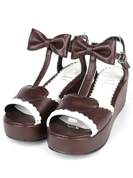 Pair of brown Lolita platform sandals tilted front view showing thick platform heel mid heel height white background flat lay photography