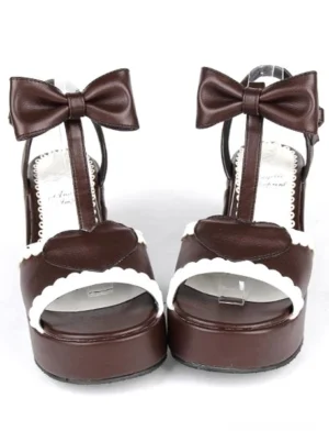 Brown PU leather Lolita platform sandals front view with bow ankle strap heart-shaped buckle and white scalloped peep toe trim flat lay