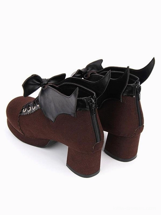 Pair of brown suede Gothic Lolita chunky heel pumps with bat wing bow and heel zipper detail, rear-side view emphasizing construction quality and design complexity