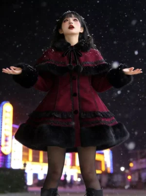 Front full body view burgundy gothic lolita winter coat with black bow neck detail furry trims ruffled lace hem female model wearing tights boots