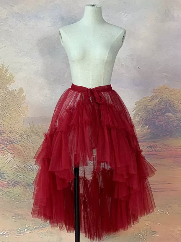 Burgundy asymmetrical high-low tulle skirt with detachable train and tie waist design showing layered ruffled tulle construction