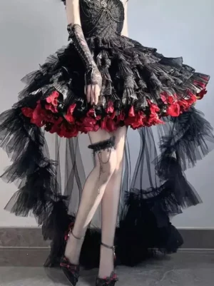 Black and burgundy gothic lolita high-low dress with ruffled tulle train detail and red floral hem trims worn by model in front view