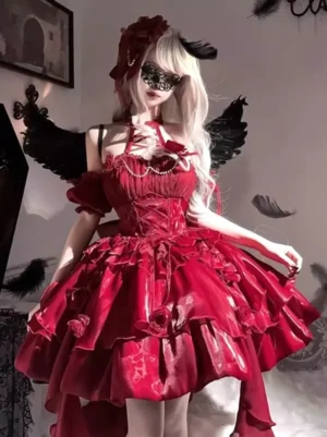 Burgundy Gothic Lolita dress front three-quarter view with 3D roses, pearl chain halter lace-up bodice, layered ruffled skirt, model wearing masquerade mask and black feather wings