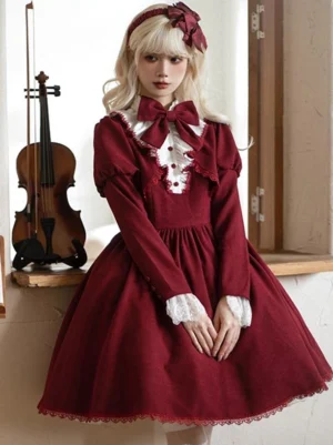 Burgundy gothic lolita dress full front view worn by model with lace collar ruffles and long puff sleeves with lace cuffs