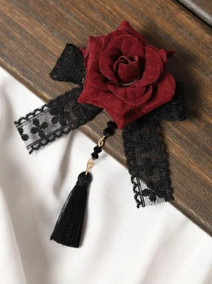 burgundy flocked rose gothic lolita hair clip with black lace bow and beaded tassel pendant flat lay on wooden background fabric