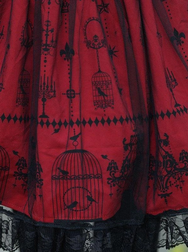 Burgundy lolita skirt fabric print detail showing black vintage gothic motifs birdcage candelabra ornamental designs on red base