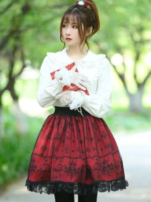 Burgundy lolita skirt close up front detail showing black elastic waistband white blouse lace trim pearl buttons red accessory