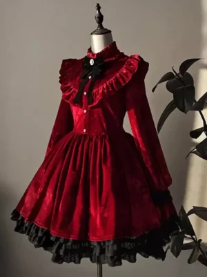 burgundy gothic lolita velvet dress with black lace trim front three quarter view on mannequin with ruffled collar and bow brooch