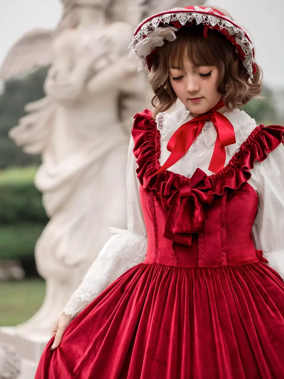 Burgundy sweet lolita JSK dress close-up detail of ruffled shoulder straps, front bow accent, and red neckline embellishment, velour fabric texture