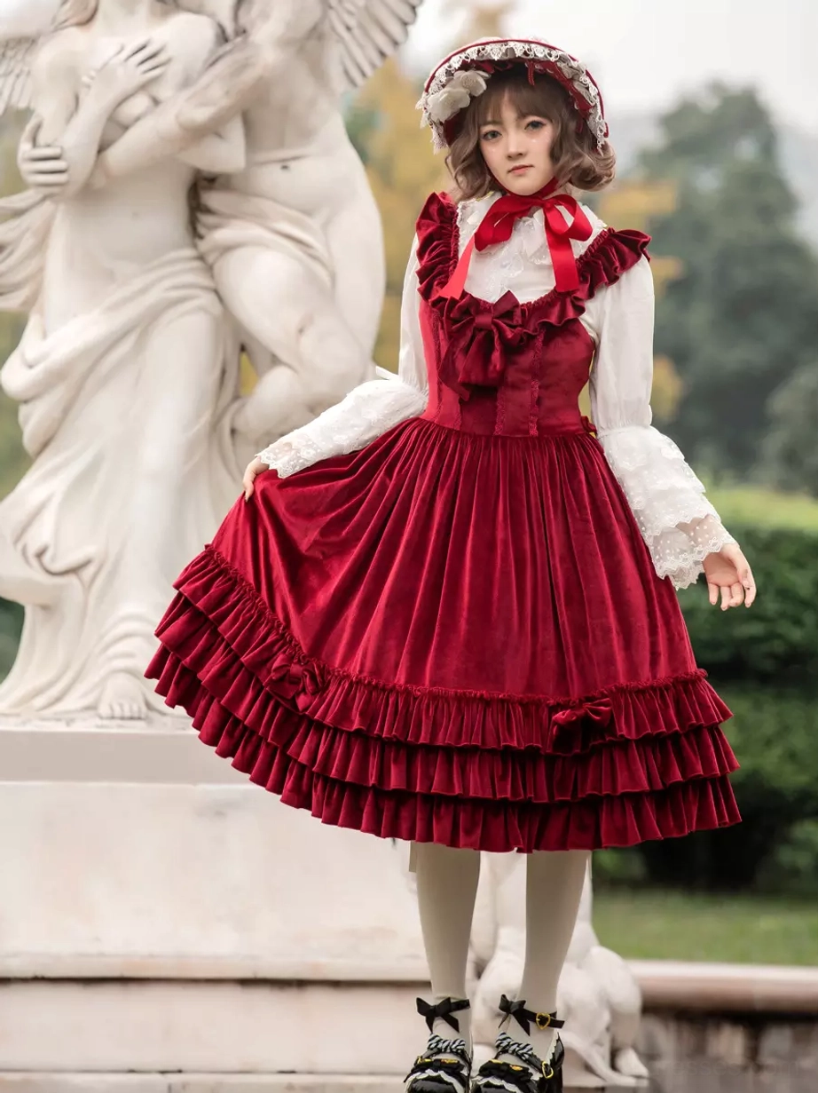 Burgundy velour sweet lolita JSK dress three-quarter side view with double-layer ruffled hem, paired with lace bonnet and Mary Jane shoes