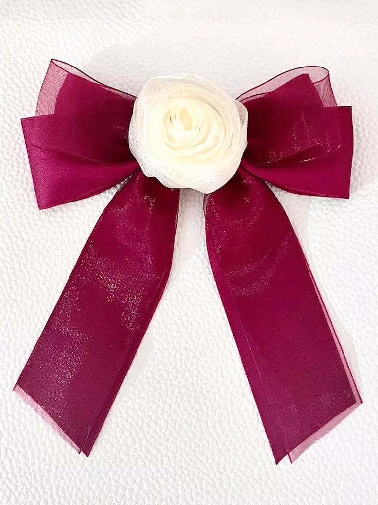 Burgundy sheer organza bow hair clip with cream rose decoration, flat lay front view on white textured background, autumn-themed sweet lolita hair accessory