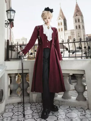 Burgundy Ouji Lolita formal coat and pants set full front view on blonde model wearing white ruffled collar and cross brooch accessories elegant Victorian-inspired ensemble