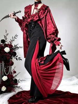 Burgundy ruffle gothic lolita vampire outfit with black wide-leg pants featuring red pleated side panels, styled with dramatic prop dagger on red velvet studio background
