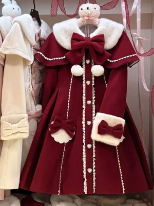 Burgundy sweet lolita cloak overcoat front view with faux fur collar, white pom-poms, large front bow, and lace trim details on flat display