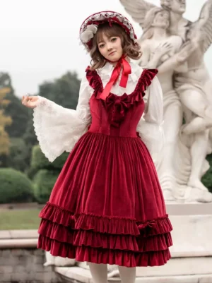 Burgundy velour sweet lolita JSK dress with ruffled shoulder straps and double-layer hem, sleeveless jumper style worn by model in front pose