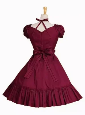 Burgundy sweet Lolita one-piece dress rear view featuring halter back strap, large decorative waist bow, and voluminous ruffled skirt construction