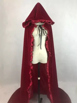 Burgundy velvet hooded cloak with ruffled trims displayed on dress form mannequin, front static view showing floor-length train and decorative neck tie - gothic lolita cape