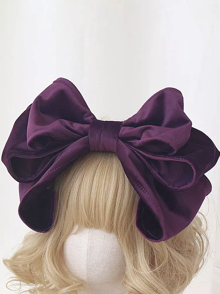 Burgundy purple velvet Lolita bow headdress with double-layered design on blonde mannequin, front top view showcasing generous proportions and rococo-inspired silhouette