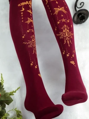Burgundy velvet lolita tights with gilded celestial cross and star motifs full leg overhead view with botanical styling