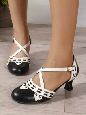 Burgundy and white sweet lolita cross-strap pumps with cutout ankle buckle details, front and side close-up view on female feet, wooden floor background, round toe kitten heel