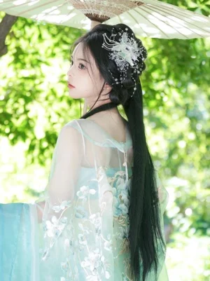 Iridescent butterfly lolita hair ornament rear view worn with cyan hanfu traditional dress and oiled paper umbrella showing crystal rhinestone details