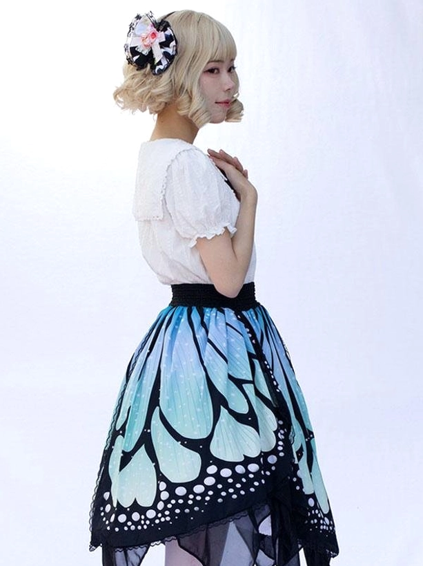 Lolita butterfly print skirt side angle view showing silhouette, irregular handkerchief hem layers, and butterfly wing print pattern from left profile