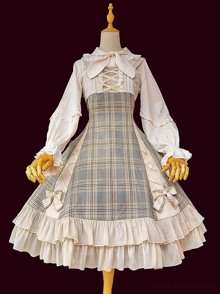 Full Lolita dress set on dress form against dark background, showing bow necktie, lace-up bodice, and plaid fabric construction details