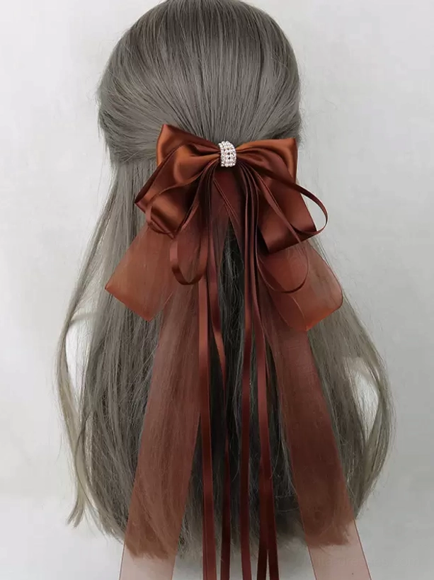 Caramel brown satin bow hair accessory with rhinestone decoration and trailing satin organza ribbons, sweet lolita headdress back view