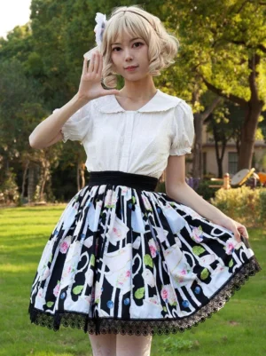 Cardcaptor Sakura inspired sweet lolita skirt with floral and tea cup print in black, front three-quarter view showcasing flared silhouette and ruffled lace hem on model with blonde wig in outdoor park setting