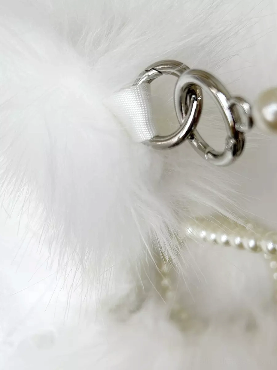 Close-up detail of silver metal lobster clasps and pearl chain strap components showing hardware quality and mixed pearl fabric strap construction