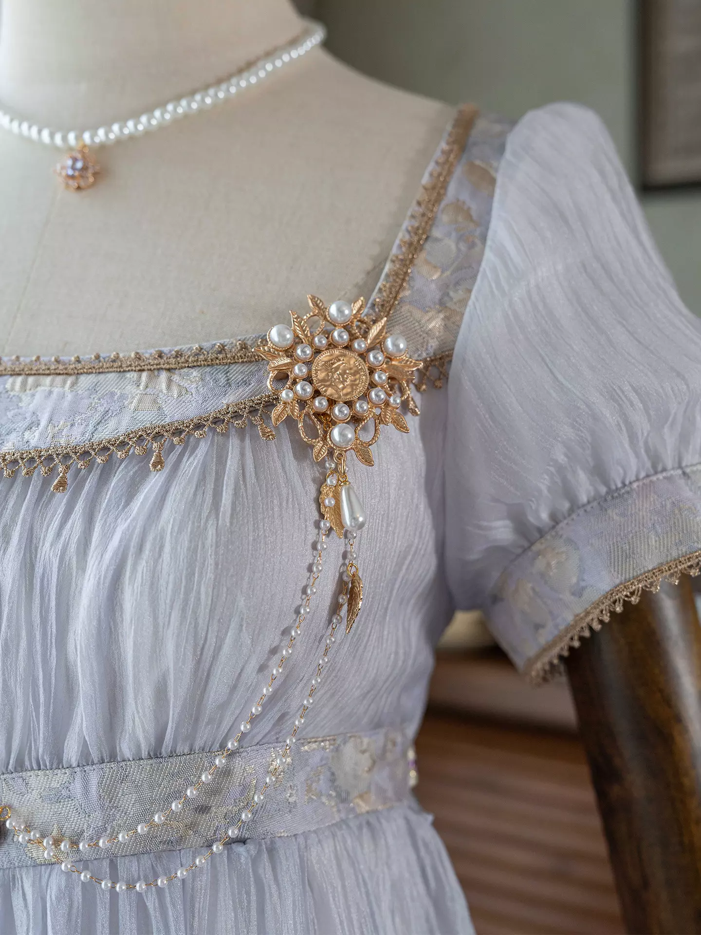 Purple Regency Lolita ball gown detail showcase featuring decorative chain embellishments, empire waist construction, and romantic fabric texture for sweet Lolita fashion