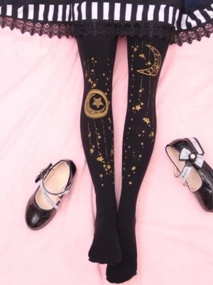 Black velvet lolita tights with golden moon star printed pattern styled with bow Mary Jane shoes on pink background overhead view sweet lolita