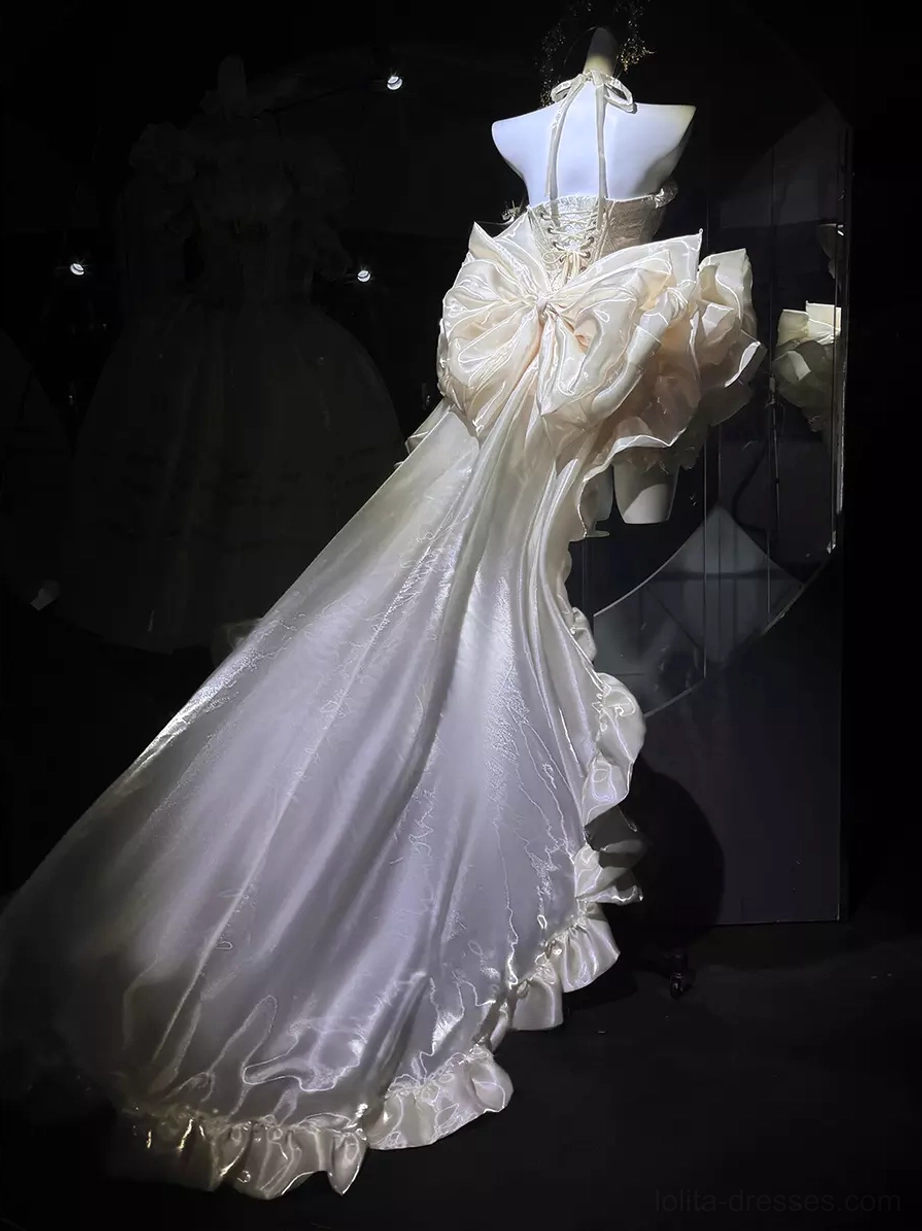 Halter neck champagne ballet lolita gown with large satin back bow, ruffled edge trim, long sweeping theatrical train, back three-quarter angle