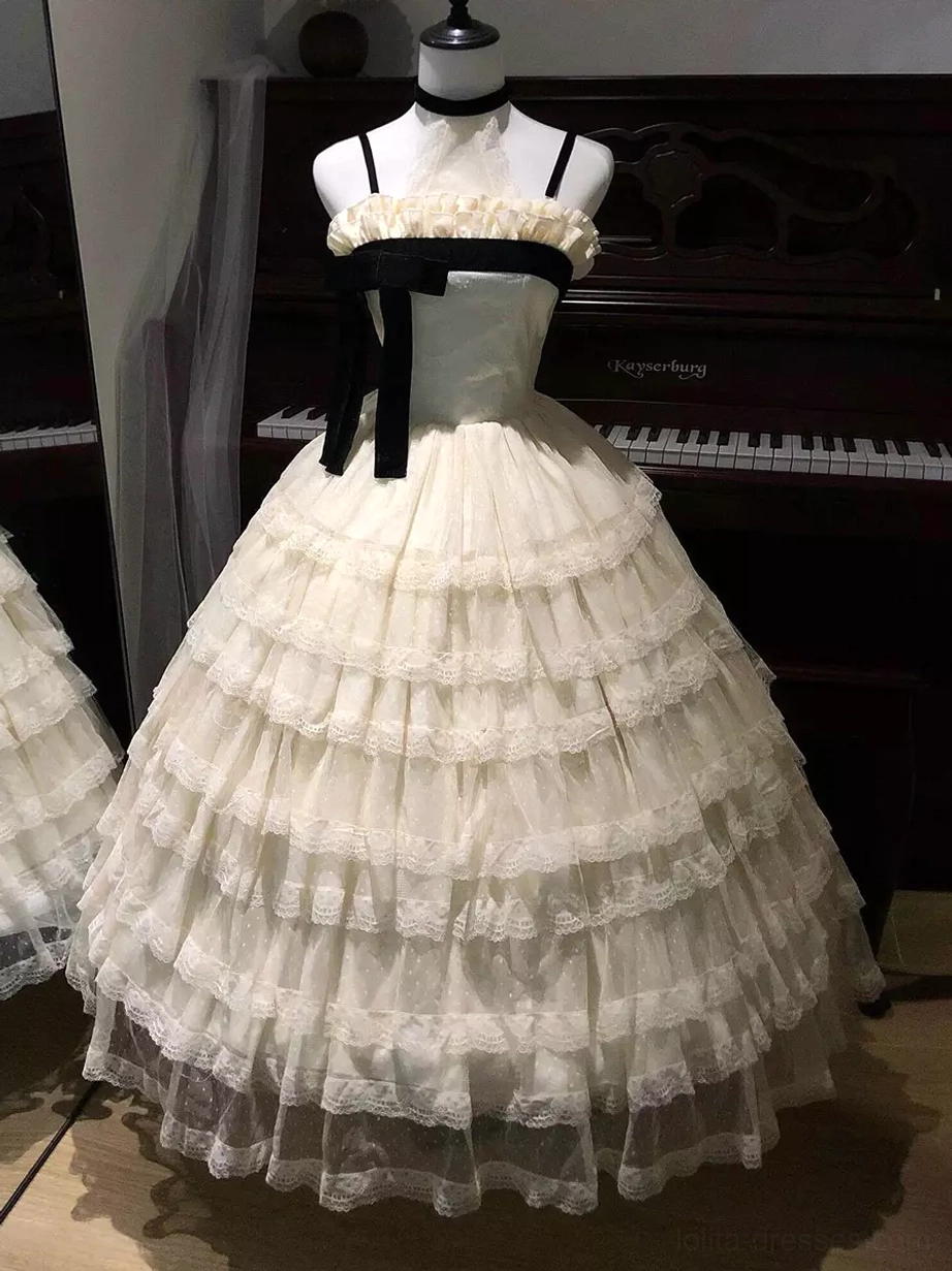 Champagne fairy lolita ball gown with spaghetti straps and black velvet bow on mannequin, featuring multi-layered ruffle tulle skirt and delicate piano background aesthetic