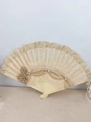 Champagne lace folding fan with pearl-adorned satin bow and fabric roses, Rococo sweet lolita accessory shown in flat lay composition