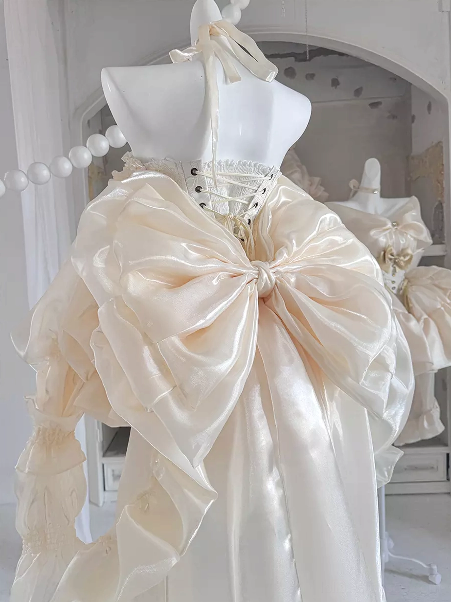 Champagne lolita dress with structured corset waist, ruffled peplum style, trained skirt, and bow embellishments for perfect fairy dress look