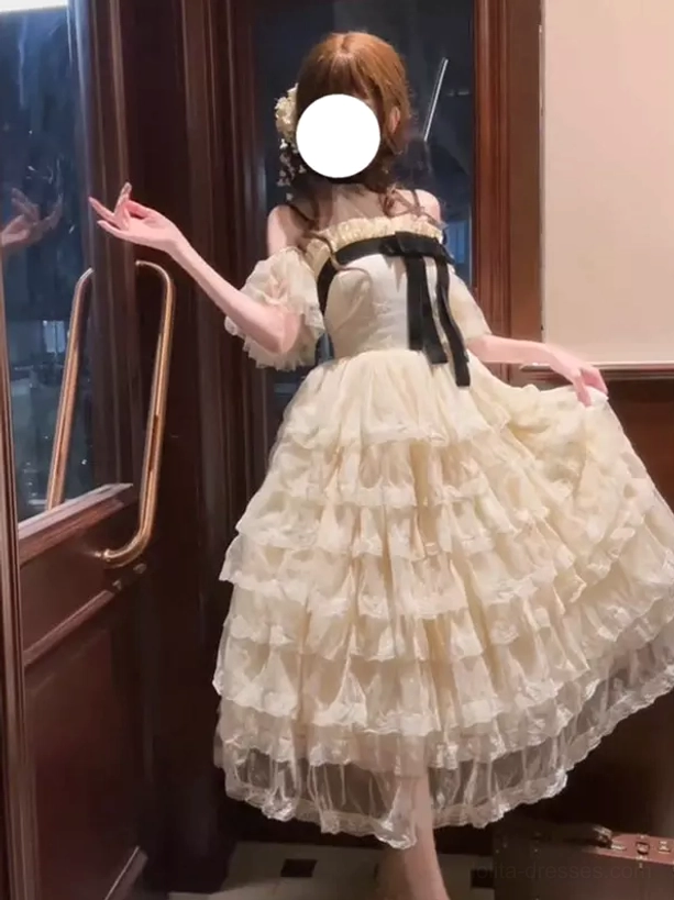 Champagne layered lolita ball gown fairy dress with off-shoulder design, voluminous tulle skirt, three-quarter view showing full silhouette and structured bell-shaped hem