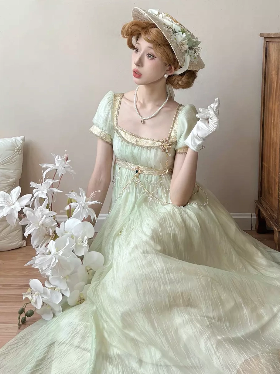Light gold champagne Regency Lolita formal evening gown featuring decorative chains, empire waist, square puff sleeves, romantic sweet Lolita fashion piece